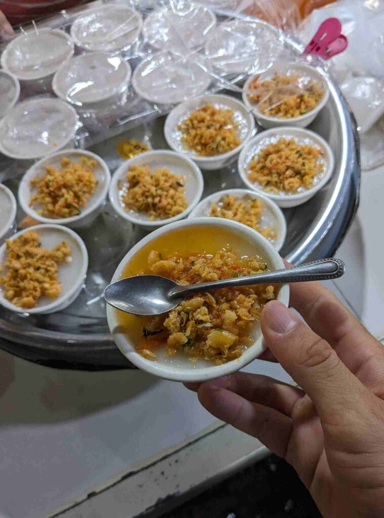 Knom Chan, a Cambodian steamed rice cake dessert, served in small bowls with savory dried shrimp topping.