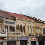 Colonial French architecture street with colorful buildings and local shops in Krong Battambang, Cambodia