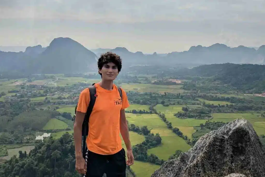 Vang Vieng Nature Views Oz Ilan overlooking Vang Vieng’s limestone mountains and lush valley — a peaceful moment in rural Laos. Time To Explore the flavors of rural Laos
