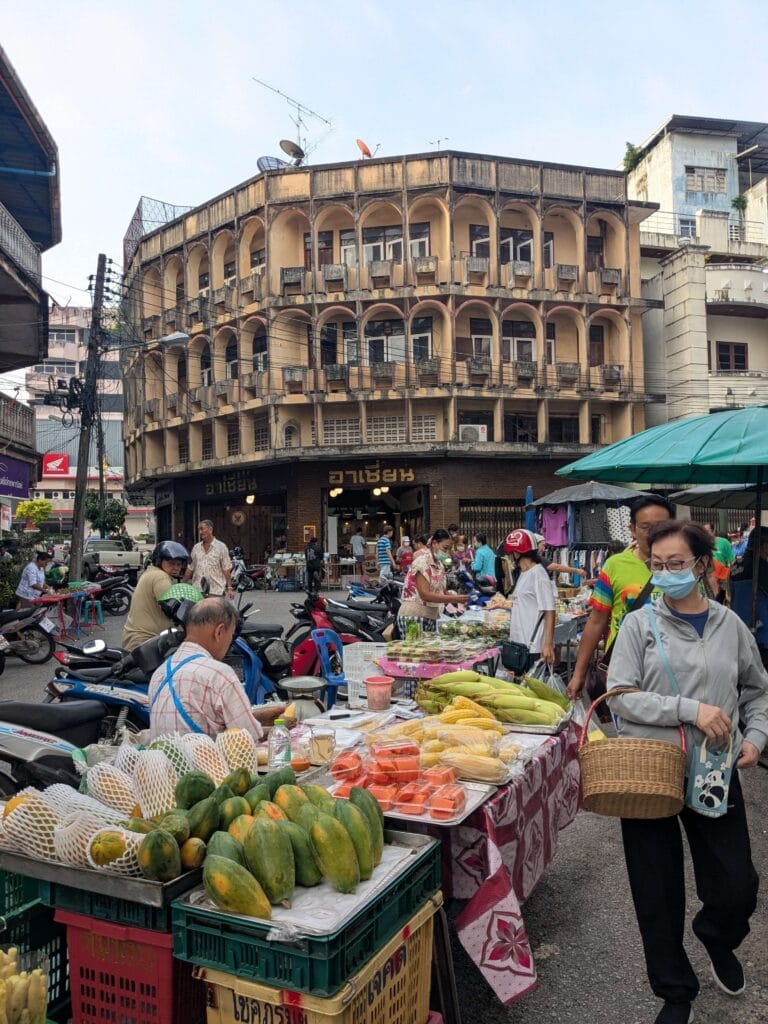 Bustling vegetable market in Trang with old kafe boran shop in the background